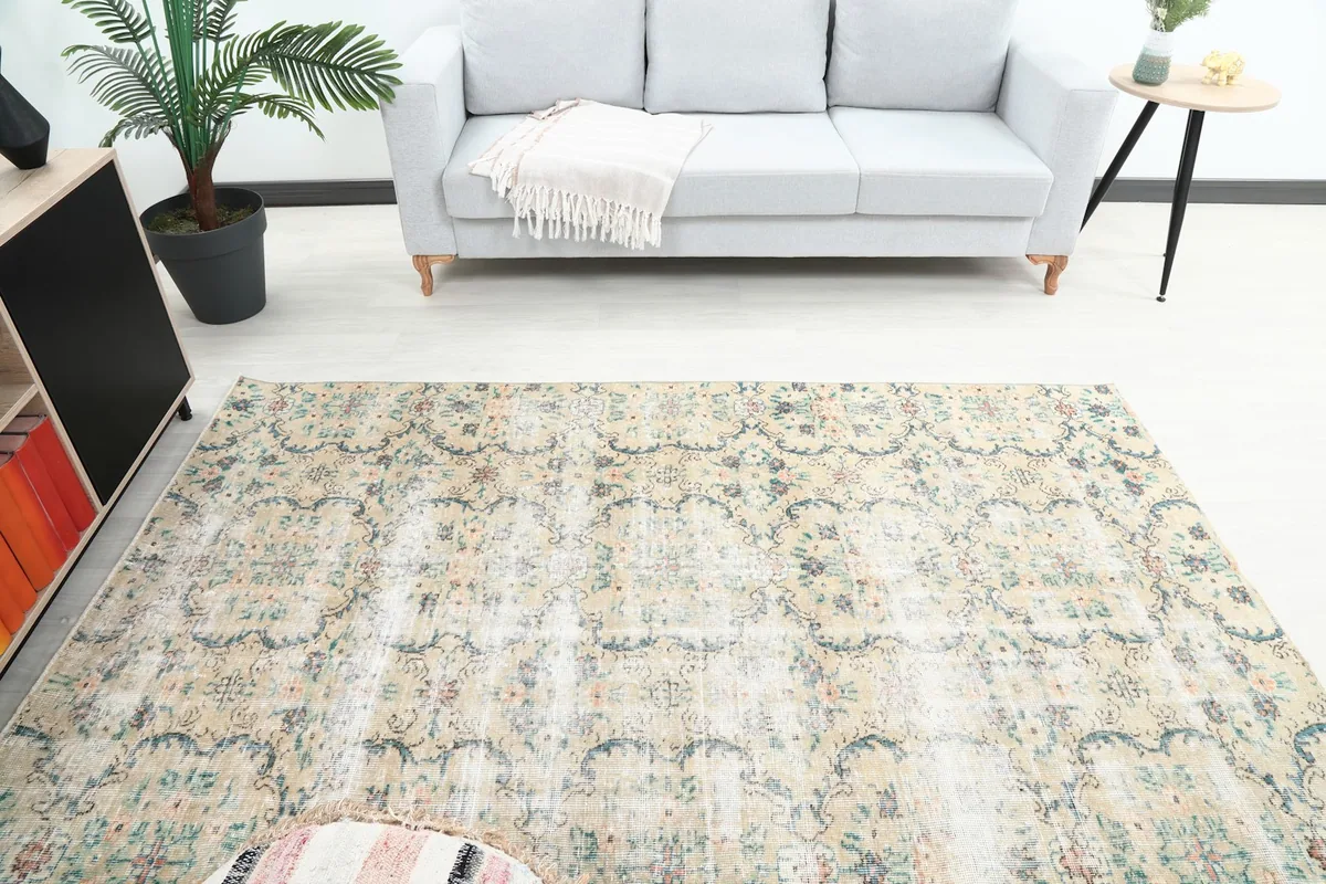 Overhead view of the vintage Anatolian rug in a room, showing overall pattern and wear