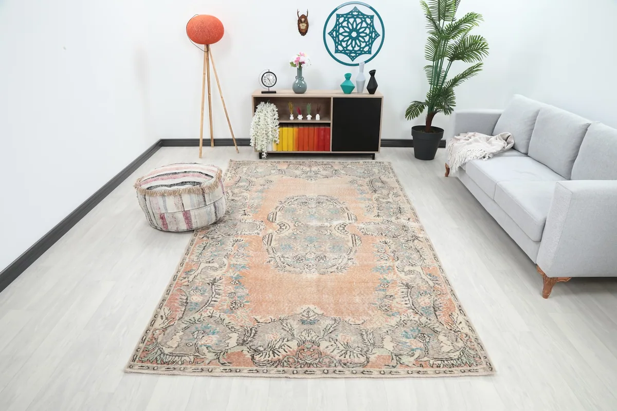 Large vintage rust and gray rug displayed in a modern living room setting