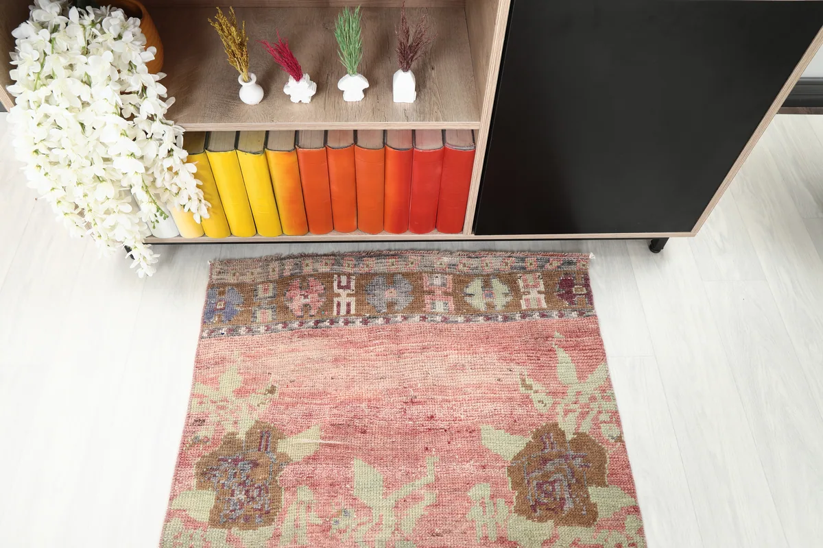 Top-down view of the Faded Rose Floral Anatolian Runner, focusing on the geometric border and floral motifs.