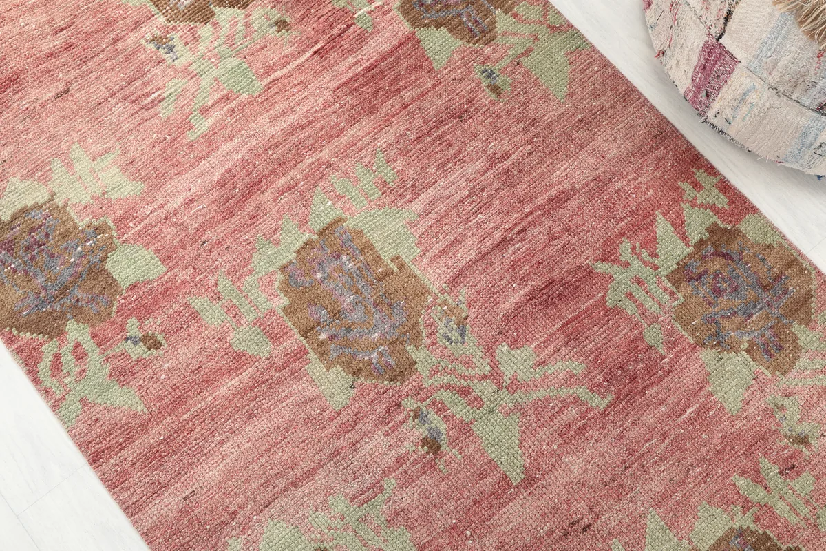Close-up of the Faded Rose Floral Anatolian Runner's surface, showing the faded rose field and olive floral patterns.