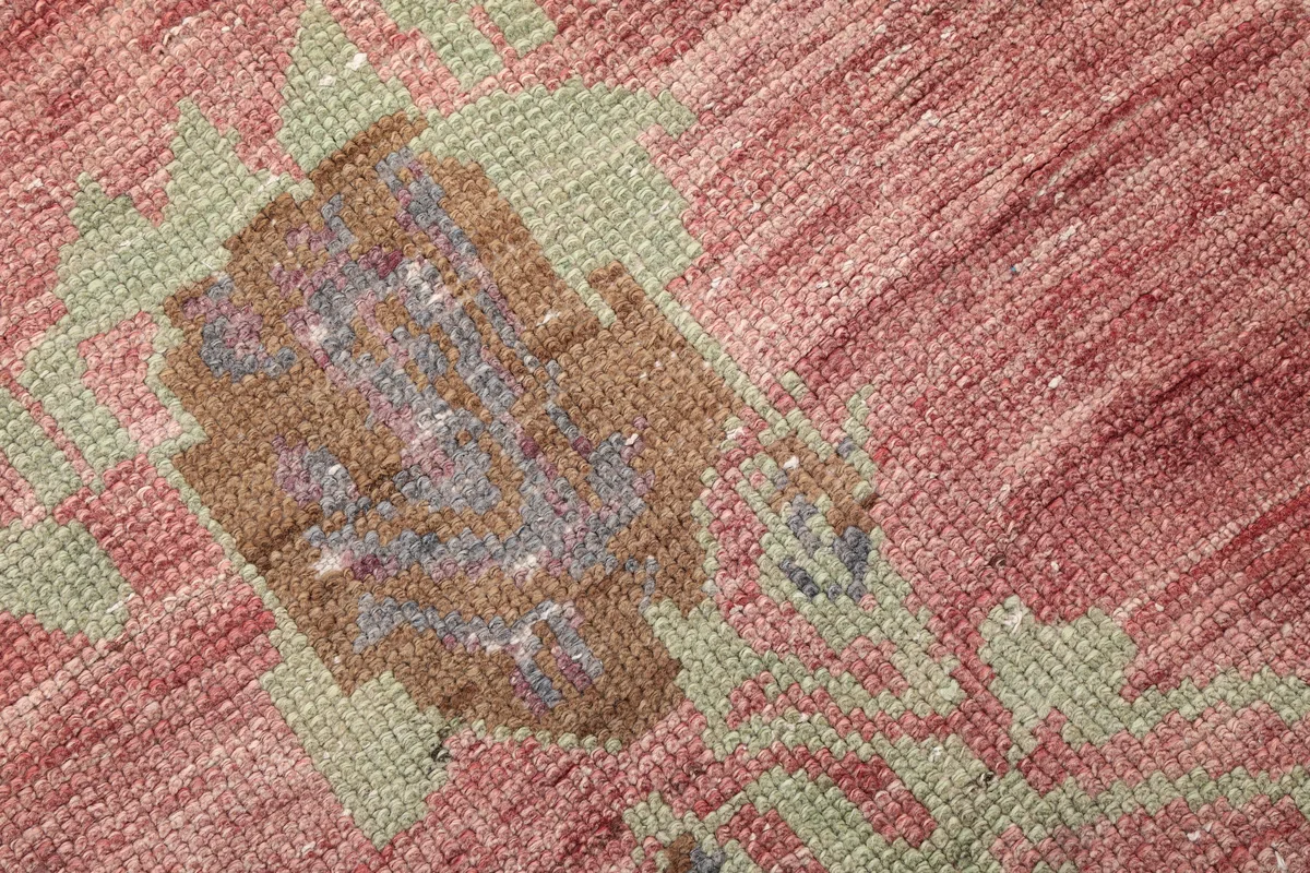 Detail of the Faded Rose Floral Anatolian Runner's low pile and visible knotting within a floral motif.