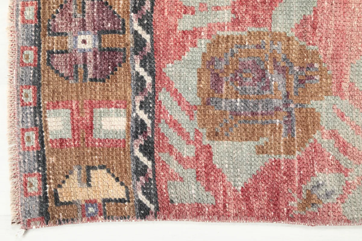Close-up of the Faded Rose Floral Anatolian Runner's intricate geometric border design and adjacent floral pattern.