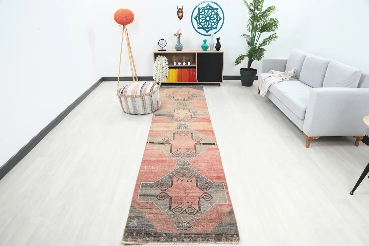 Vintage runner rug in a modern living space, showing its full length in a hallway setting