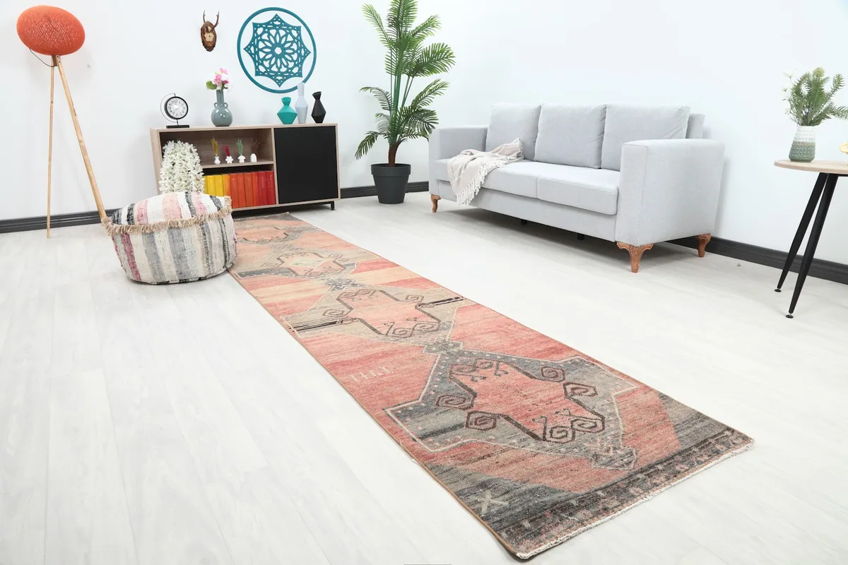 Angled view of the rose and gray runner rug in a room, highlighting its placement and scale