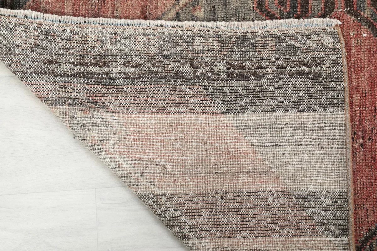 Underside view of the rug, revealing the tightly woven cotton foundation and hand-knotted construction