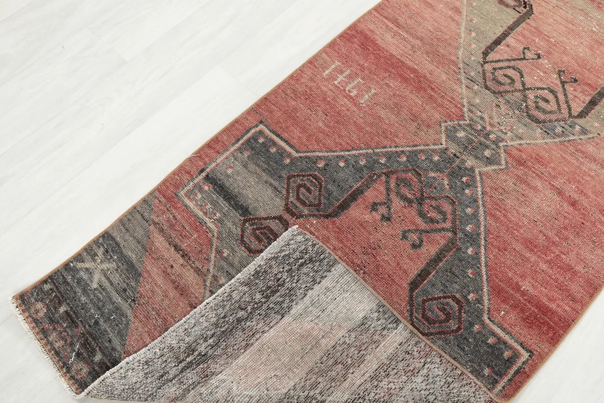 View of the rug folded to show the wool pile texture and the cotton foundation