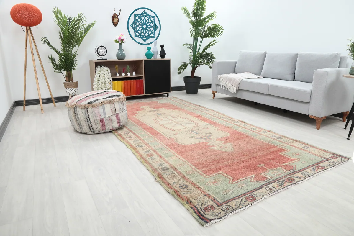 Angled view of the Rust Medallion Anatolian Area Rug in a living room, showing its length.