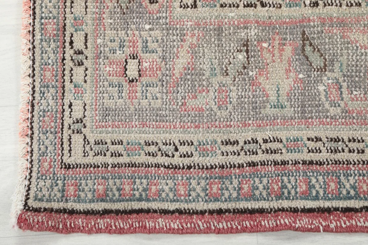 Detailed shot of the outer border and fringe, showing the intricate hand-knotted wool construction.