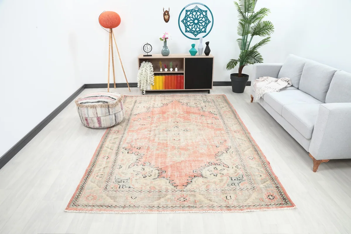 Vintage Anatolian rug in a modern living room setting with a light gray sofa and wooden furniture