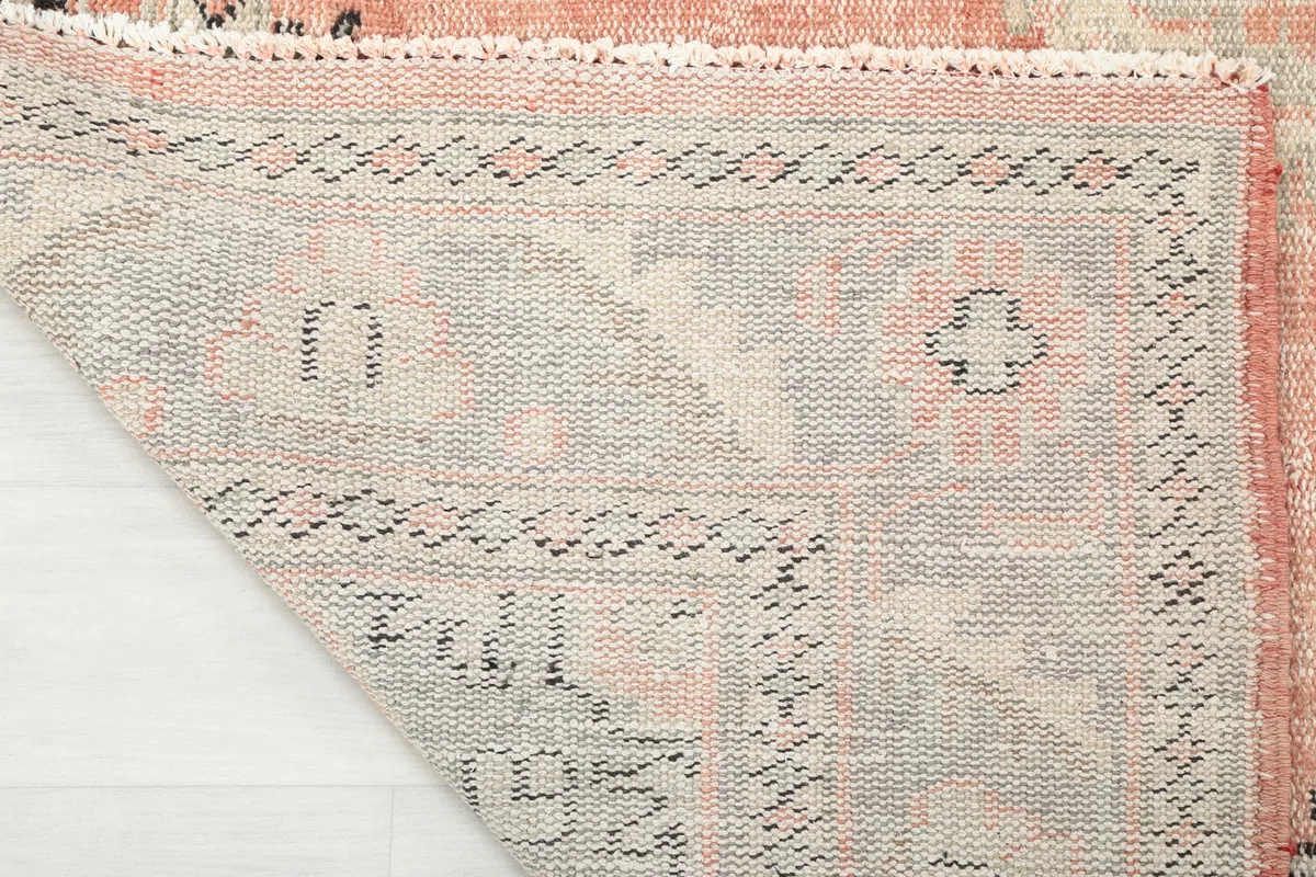 Close-up of the rug's reverse side, showing the tight knotting and wool pile on cotton foundation