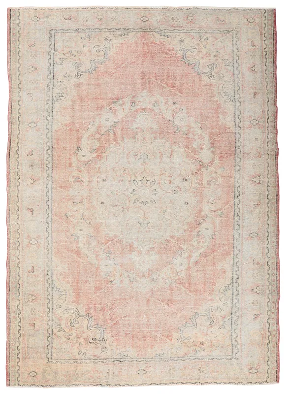 Full top view of the vintage rose and beige medallion rug on a white background
