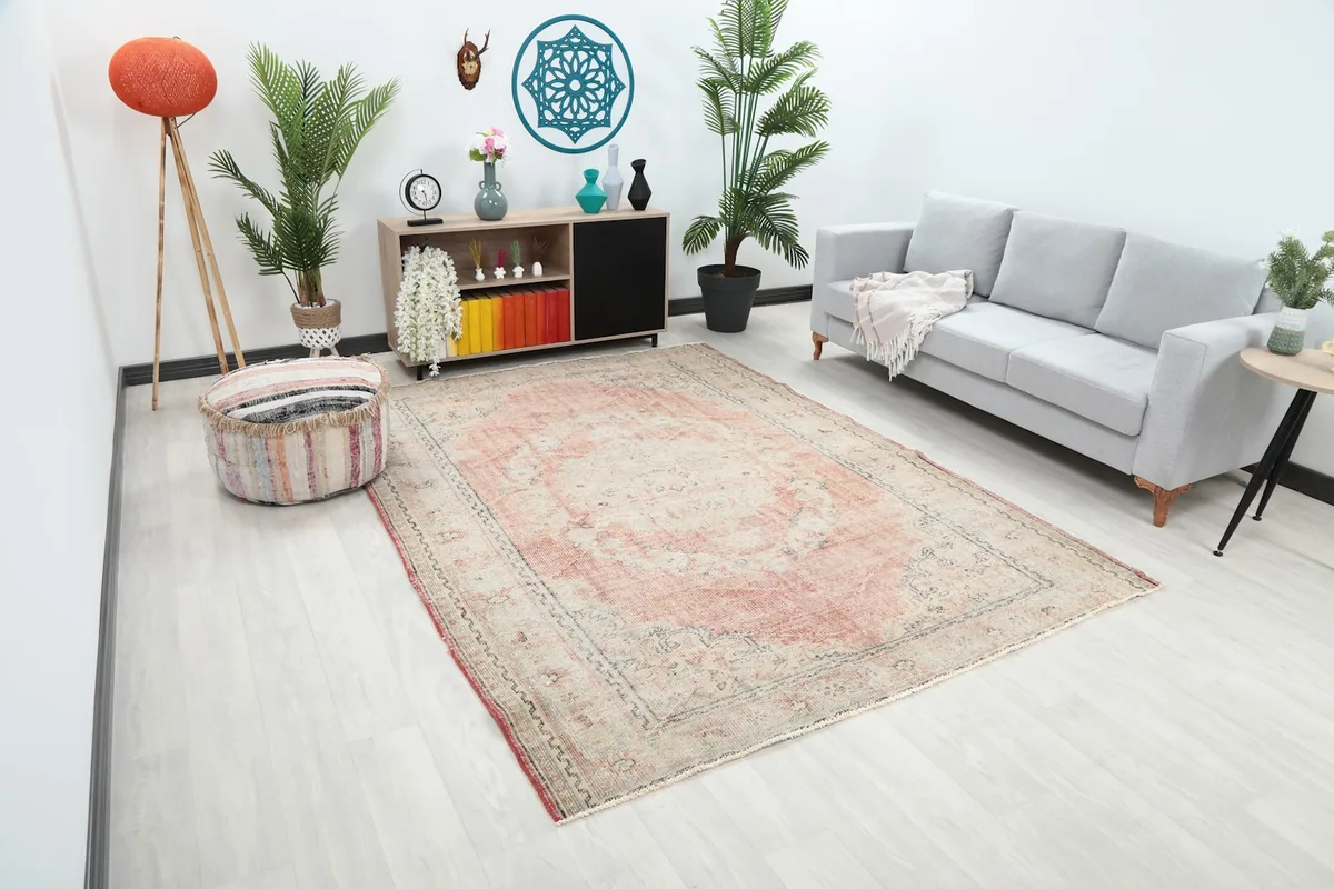 Angle view of the rose and beige rug in a modern living space with light flooring