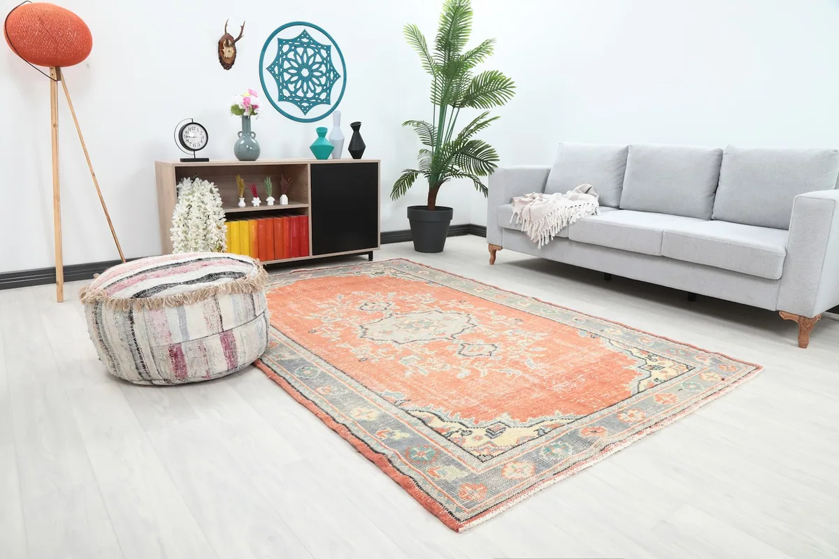 Angled view of the rust and gray vintage rug in a modern living space.