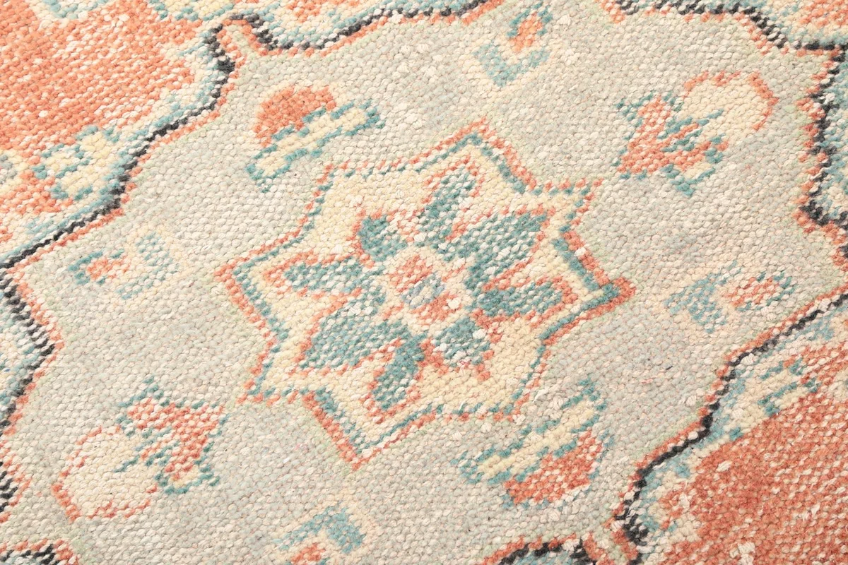 Extreme close-up of the intricate star motif within the central medallion, showing wool texture.