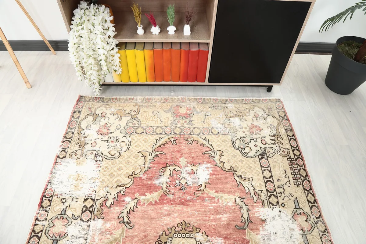 Top-down view of the rug from one end, showing the distressed texture and color variations in a room