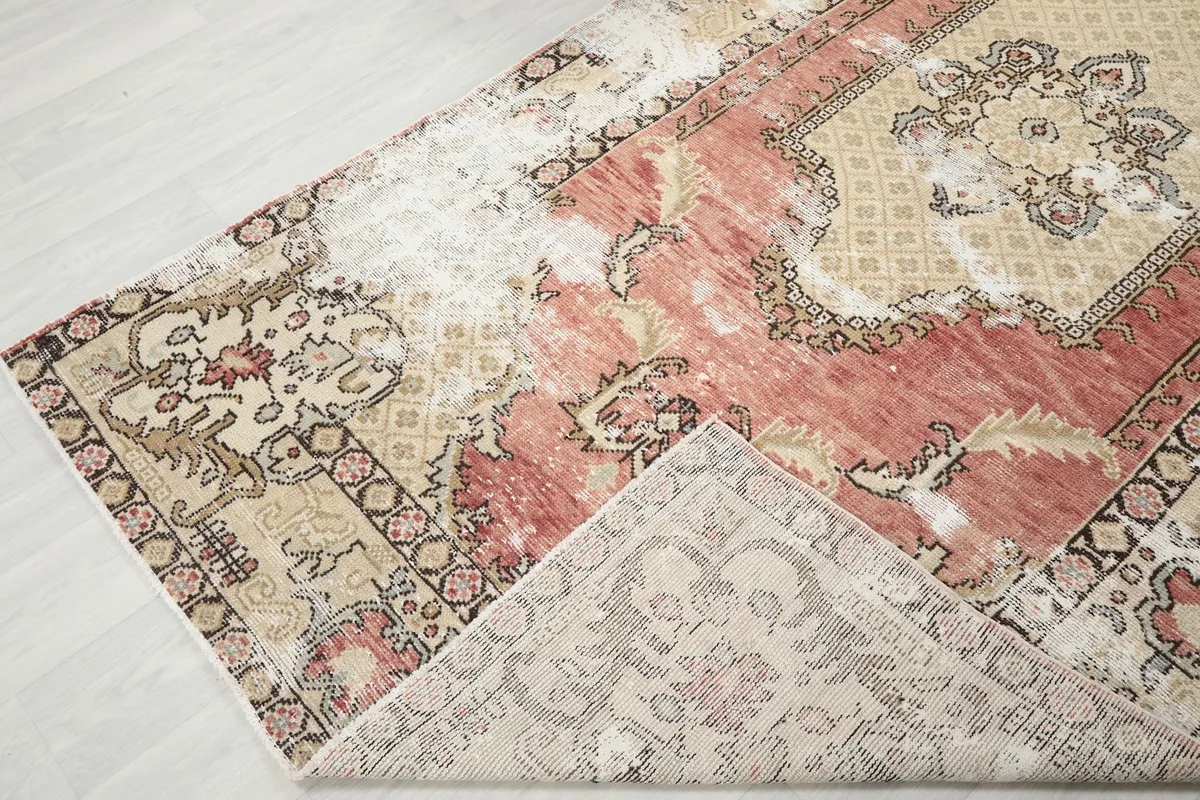 View of the rug's back, revealing the hand-knotted cotton foundation and wool pile construction
