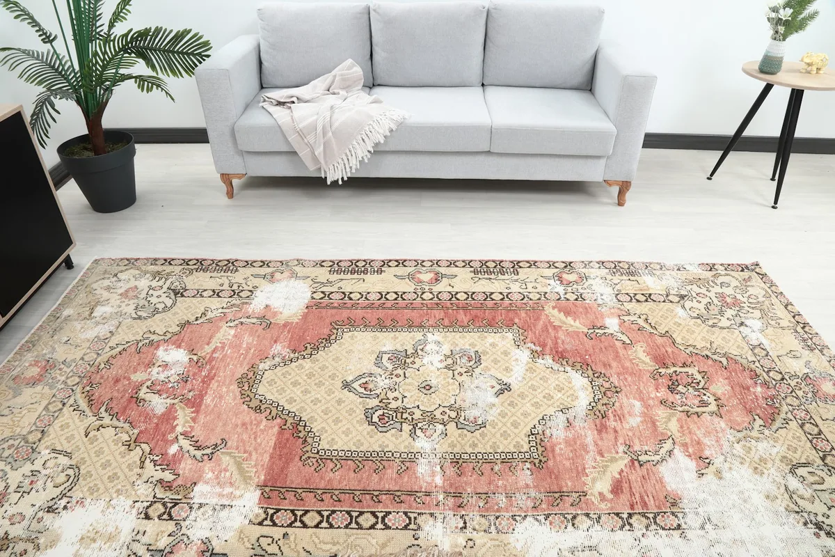 Overhead view of the rug in a room setting, highlighting its central medallion and overall color palette