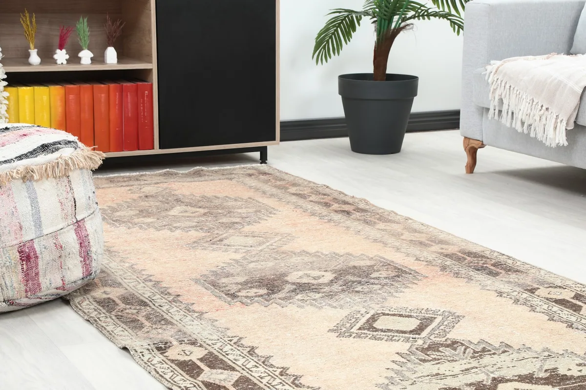 Close-up of the runner in a room, highlighting the faded rose color and geometric patterns