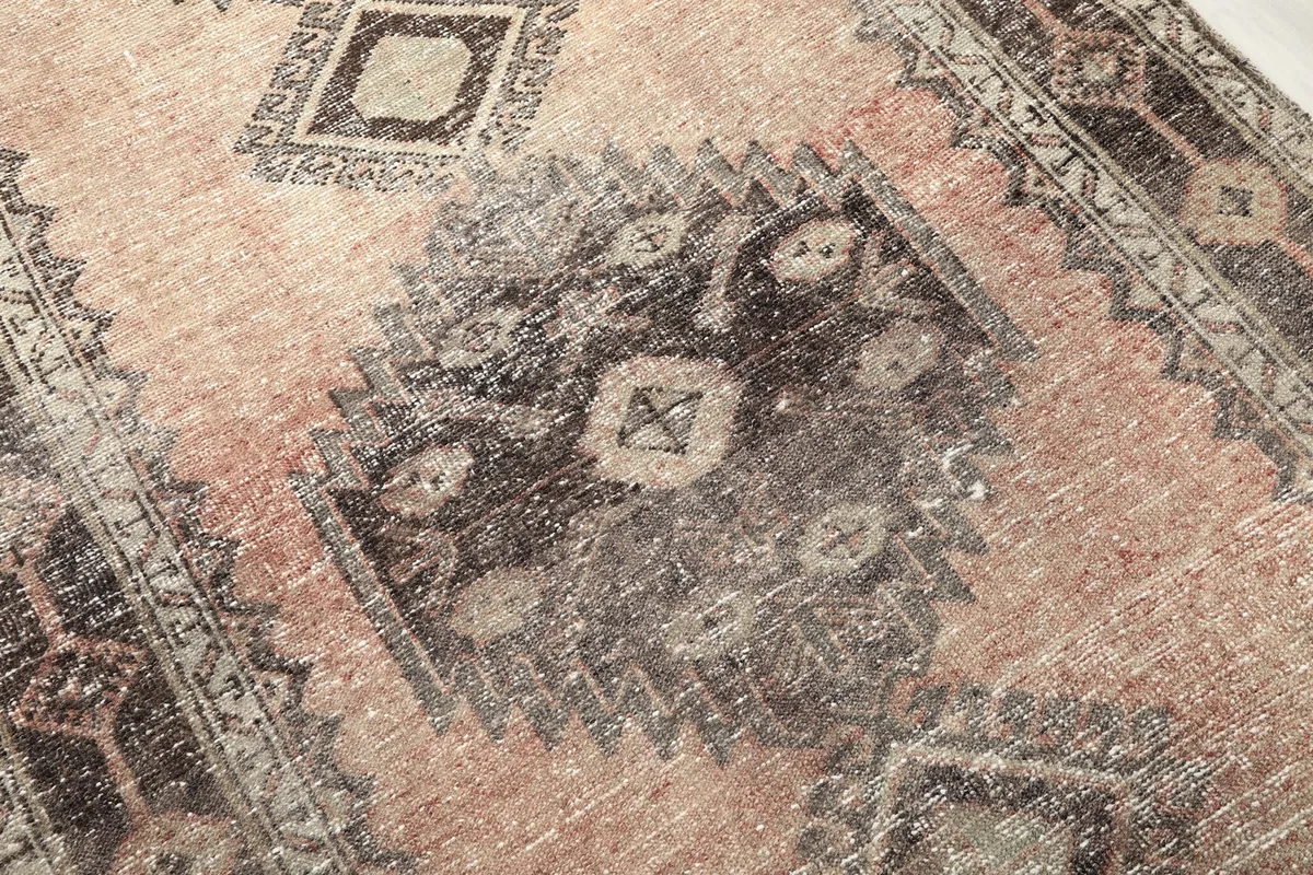 Detailed view of the wool pile, showing texture and color variations in the tribal pattern