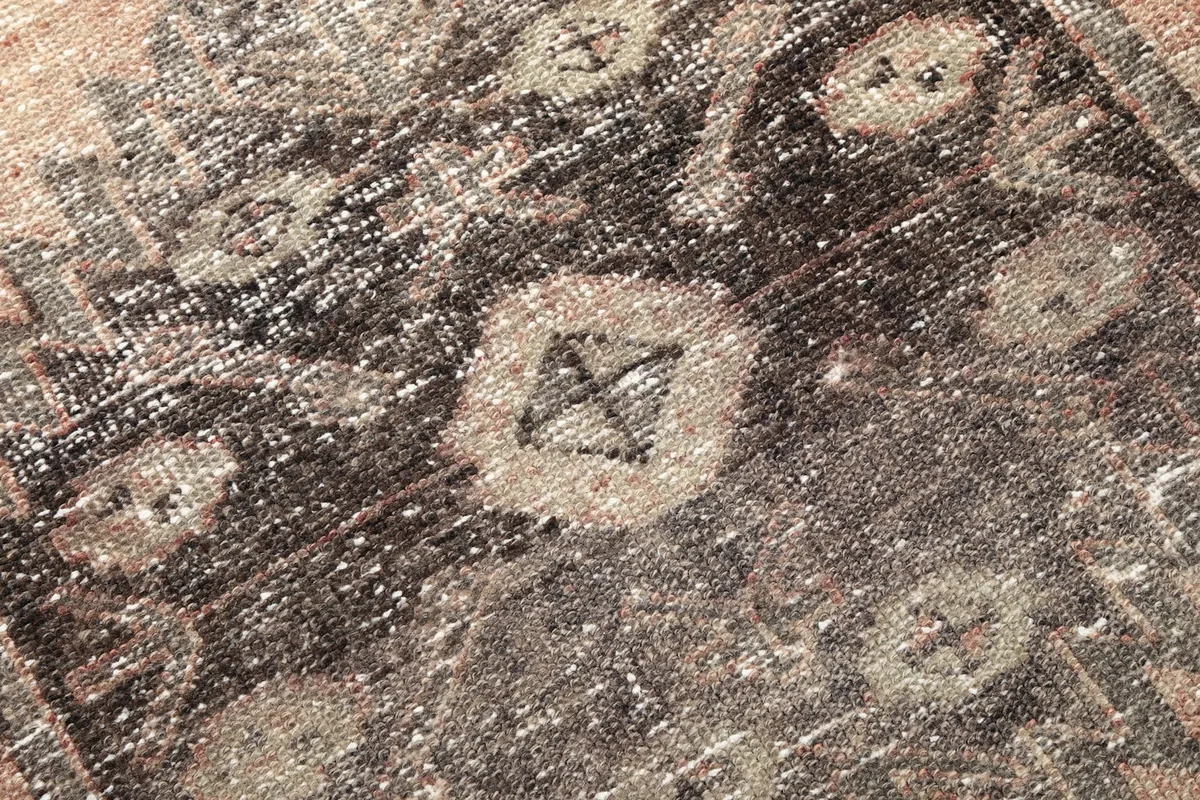 Extreme close-up of the hand-knotted wool pile, revealing individual fibers and subtle wear
