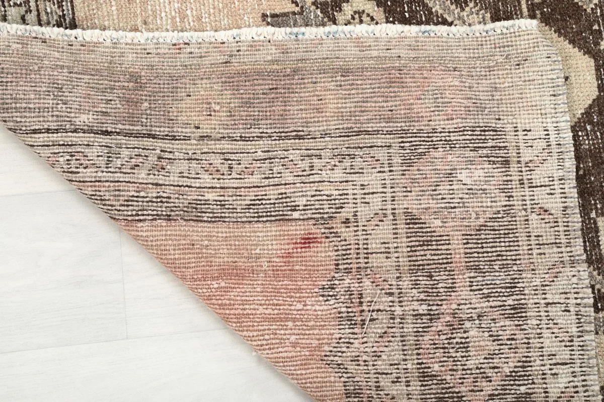 Underside view of the hand-knotted cotton foundation, showing the rug's construction