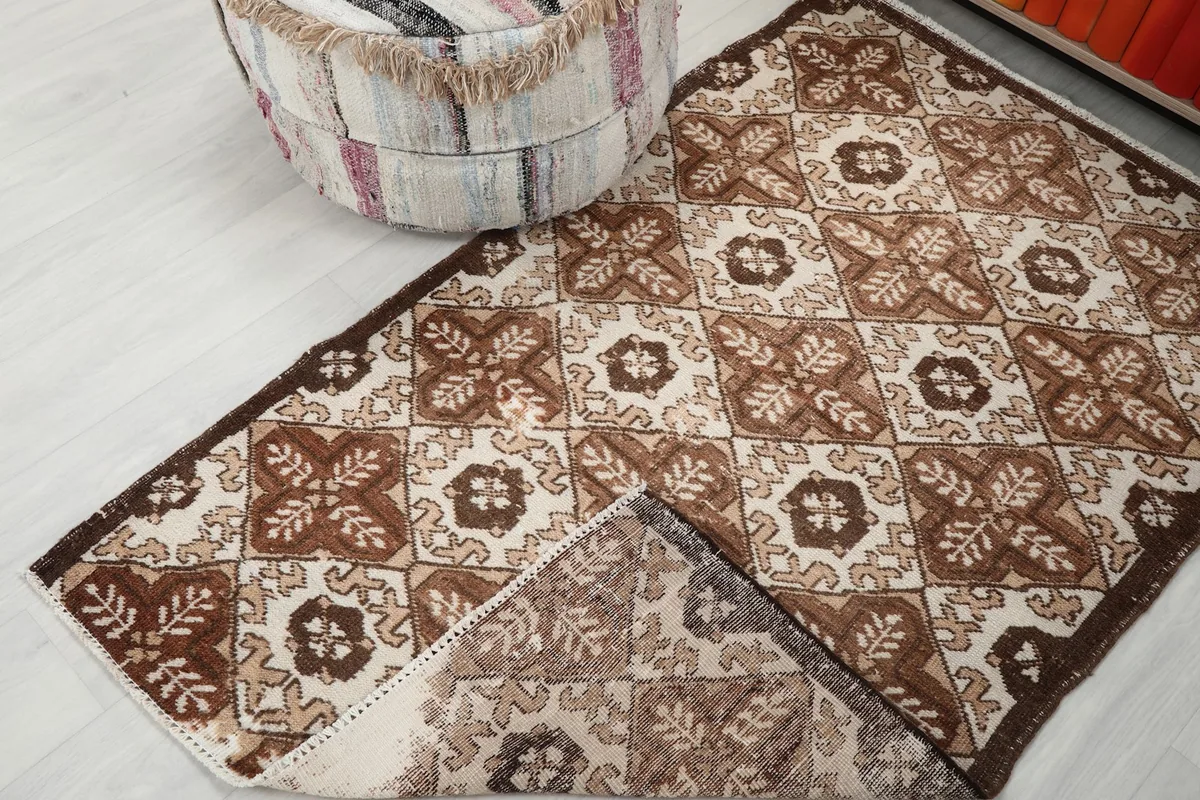 View of the rug's low pile and underside, showing the cotton foundation