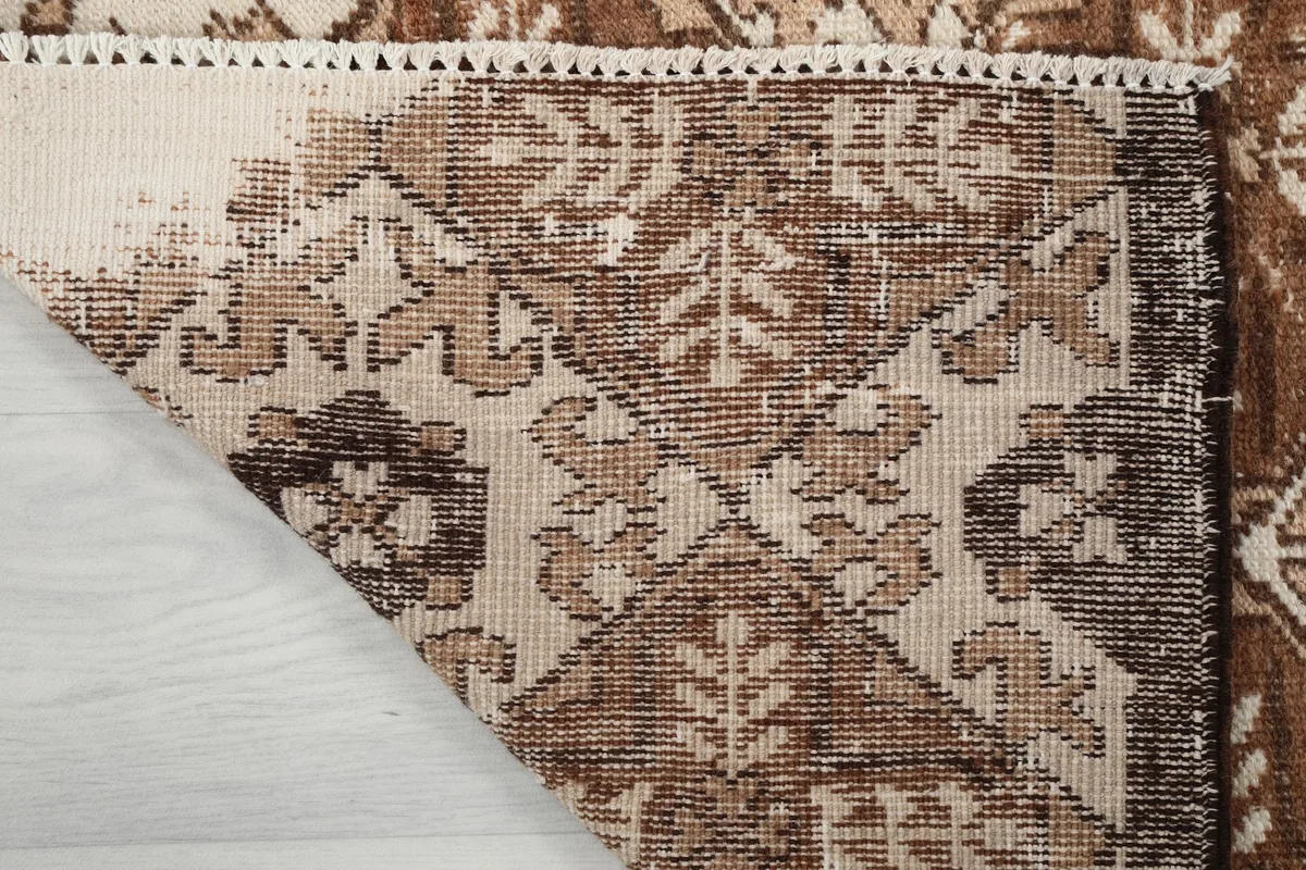 Close-up of the rug's back, revealing the hand-knotted construction and foundation
