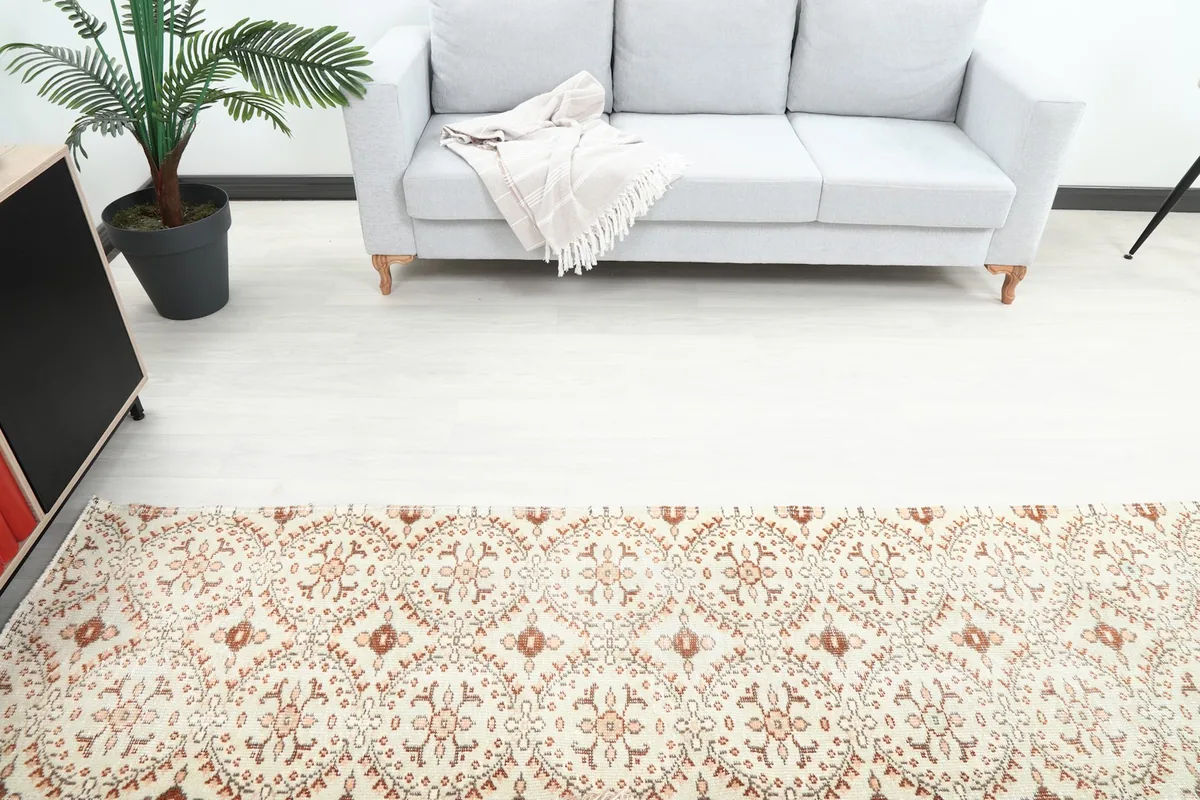Overhead view showing a section of the runner rug in front of a light gray sofa, highlighting the pattern.