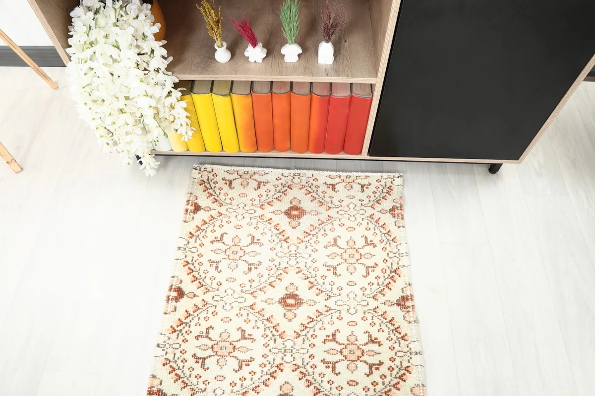 Overhead shot of the runner rug's end, positioned below a bookshelf with colorful books.