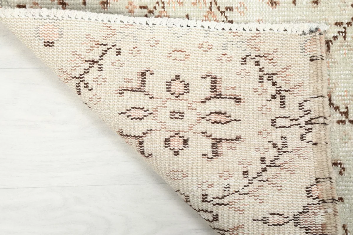 Another view of the rug's underside, showcasing the hand-knotted construction and foundation threads.