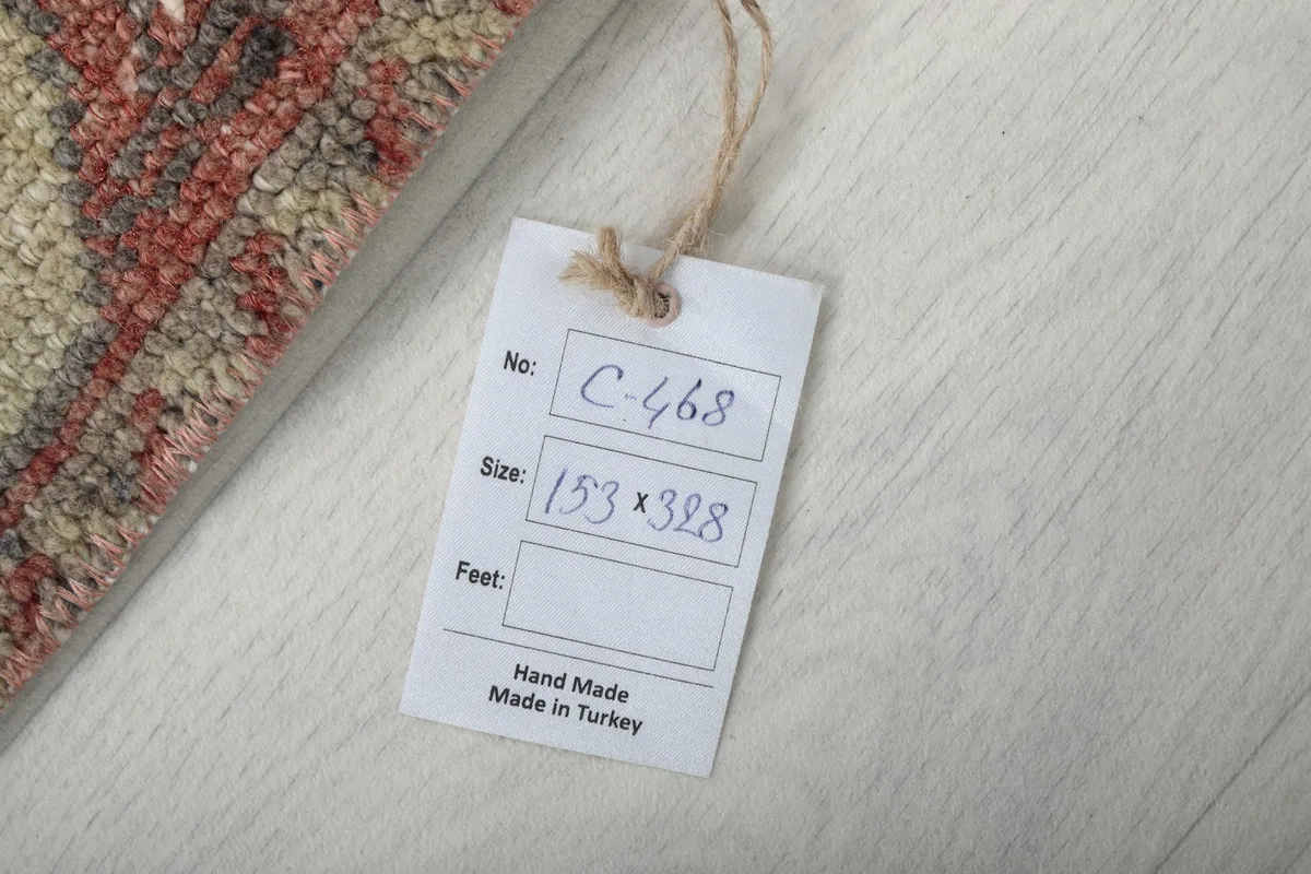 Tag showing the rug's dimensions as 153 x 328 cm and confirming it is hand-made in Turkey.