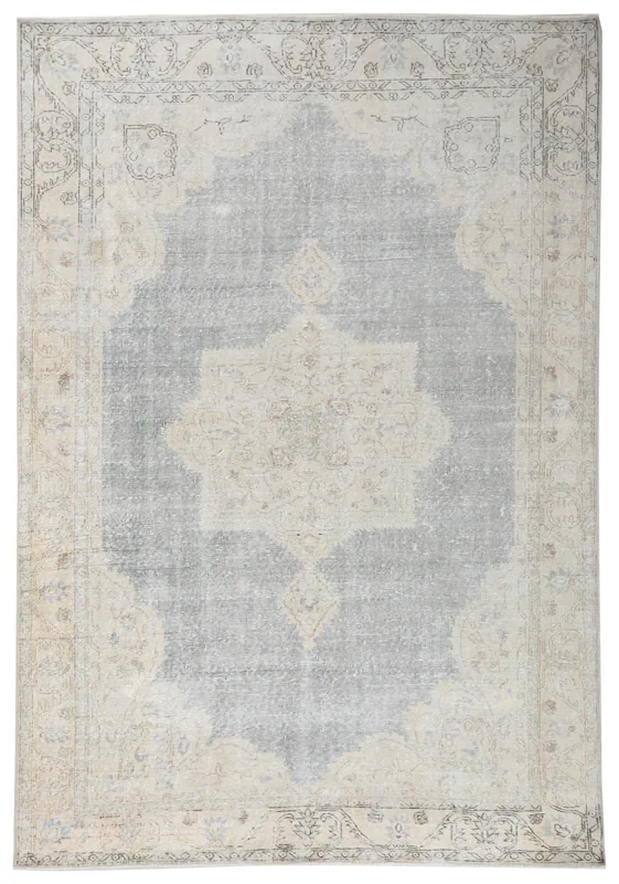 Full overhead view of the vintage Anatolian area rug with gray field and ivory medallion.