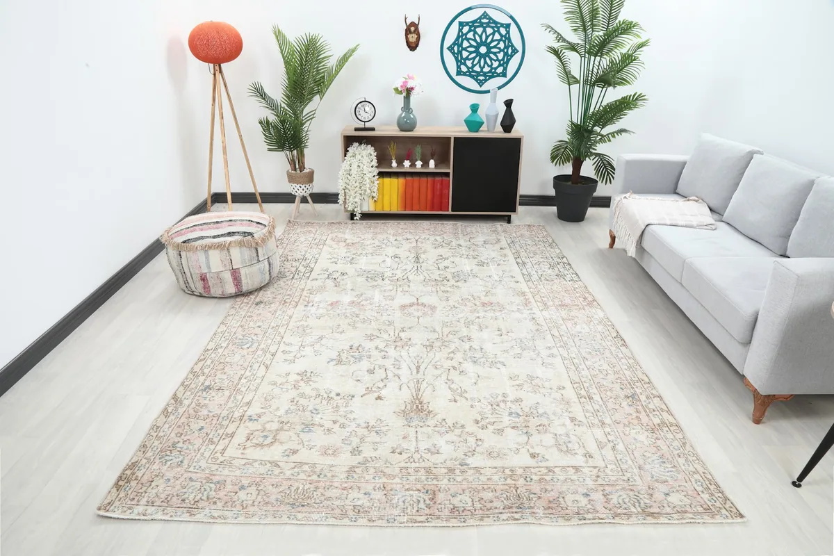 Vintage ivory floral rug displayed in a modern living room setting from an angle