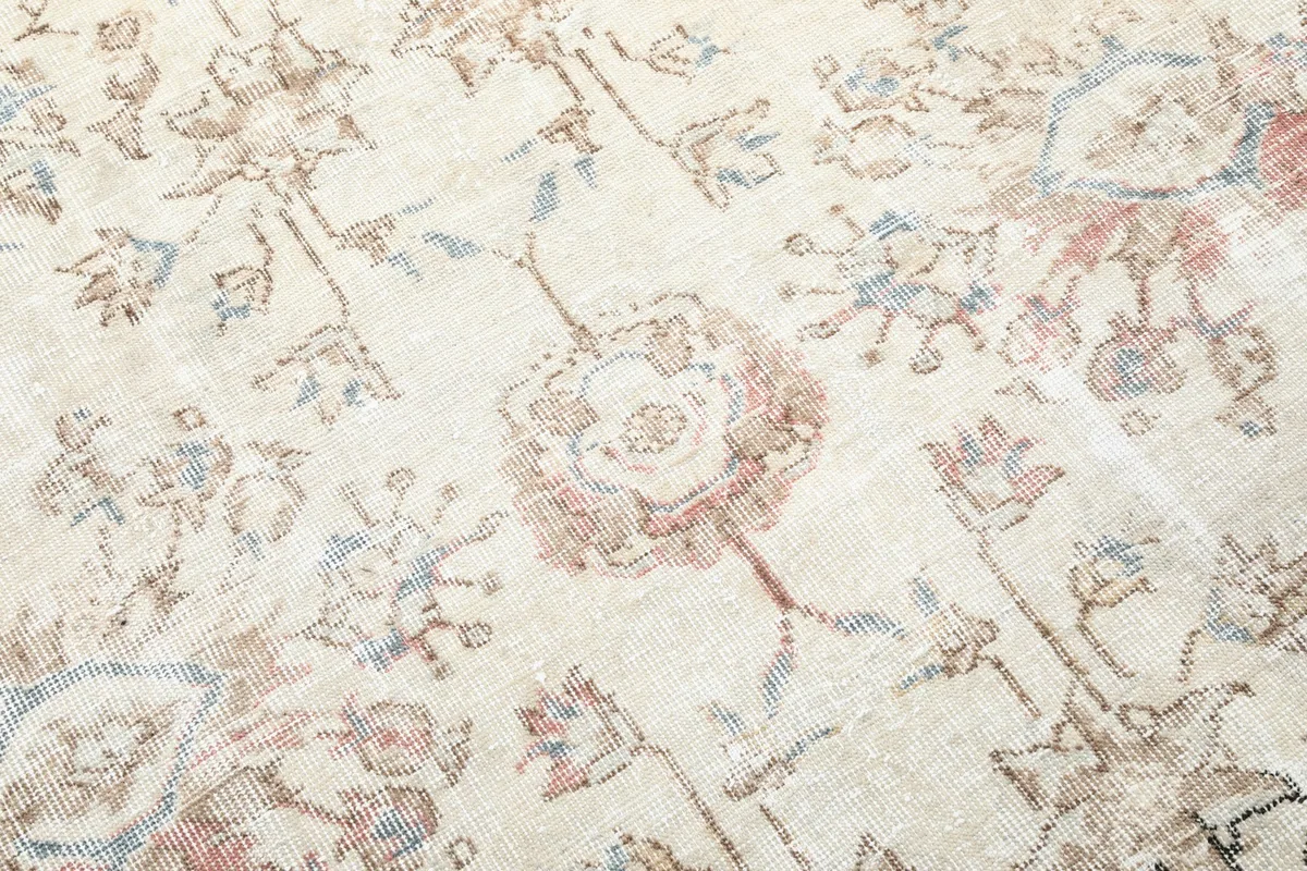 Close-up of the hand-knotted wool pile showing individual floral elements