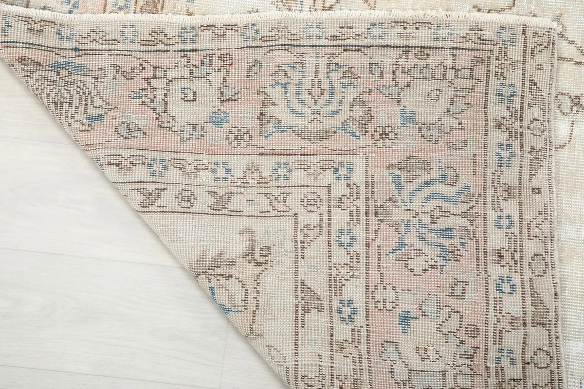 Underside and corner of the rug, revealing the cotton foundation and knotting