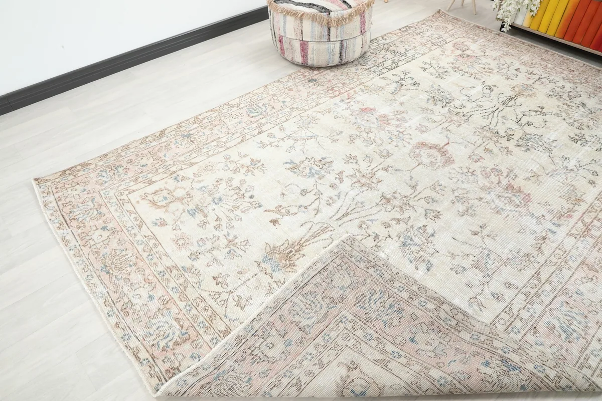 Corner of the rug folded back, showing the overall pattern and texture