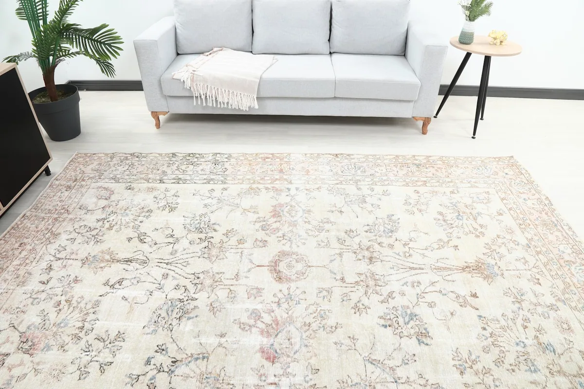 Overhead view of the vintage rug in a living room, positioned in front of a sofa