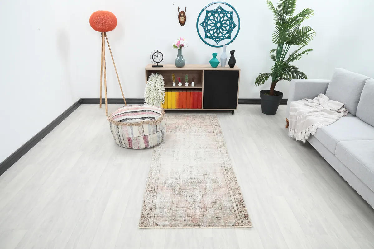 Faded Beige Geometric Medallion Runner in a modern living space, viewed from a distance.