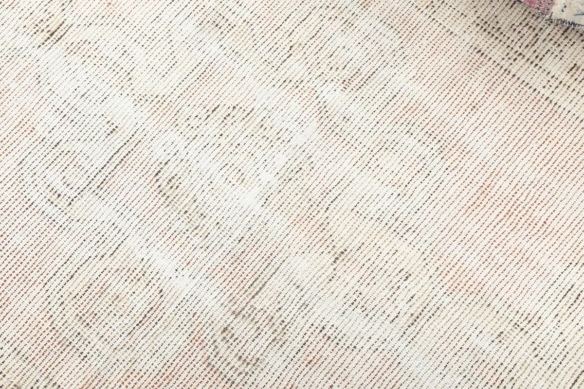 Close-up of the Faded Beige Geometric Medallion Runner's low pile and visible knotting structure.
