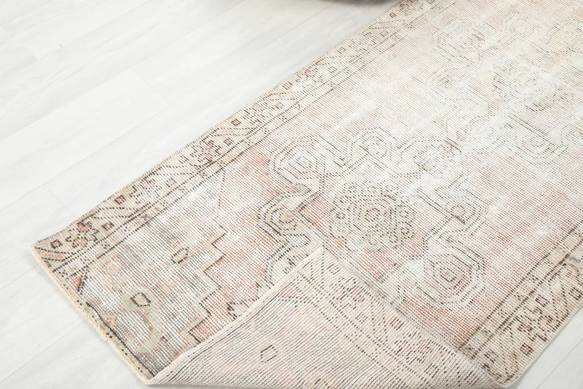 Faded Beige Geometric Medallion Runner folded, revealing the reverse side and construction.