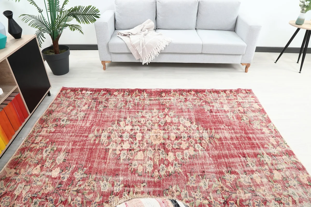Overhead view of the red vintage rug in a living room, showing the full design and surrounding furniture