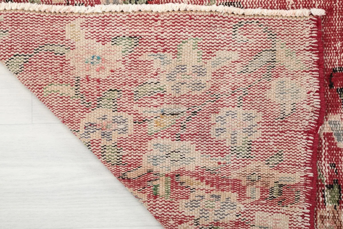 Detail of the rug's reverse side, revealing the hand-knotted construction and cotton foundation