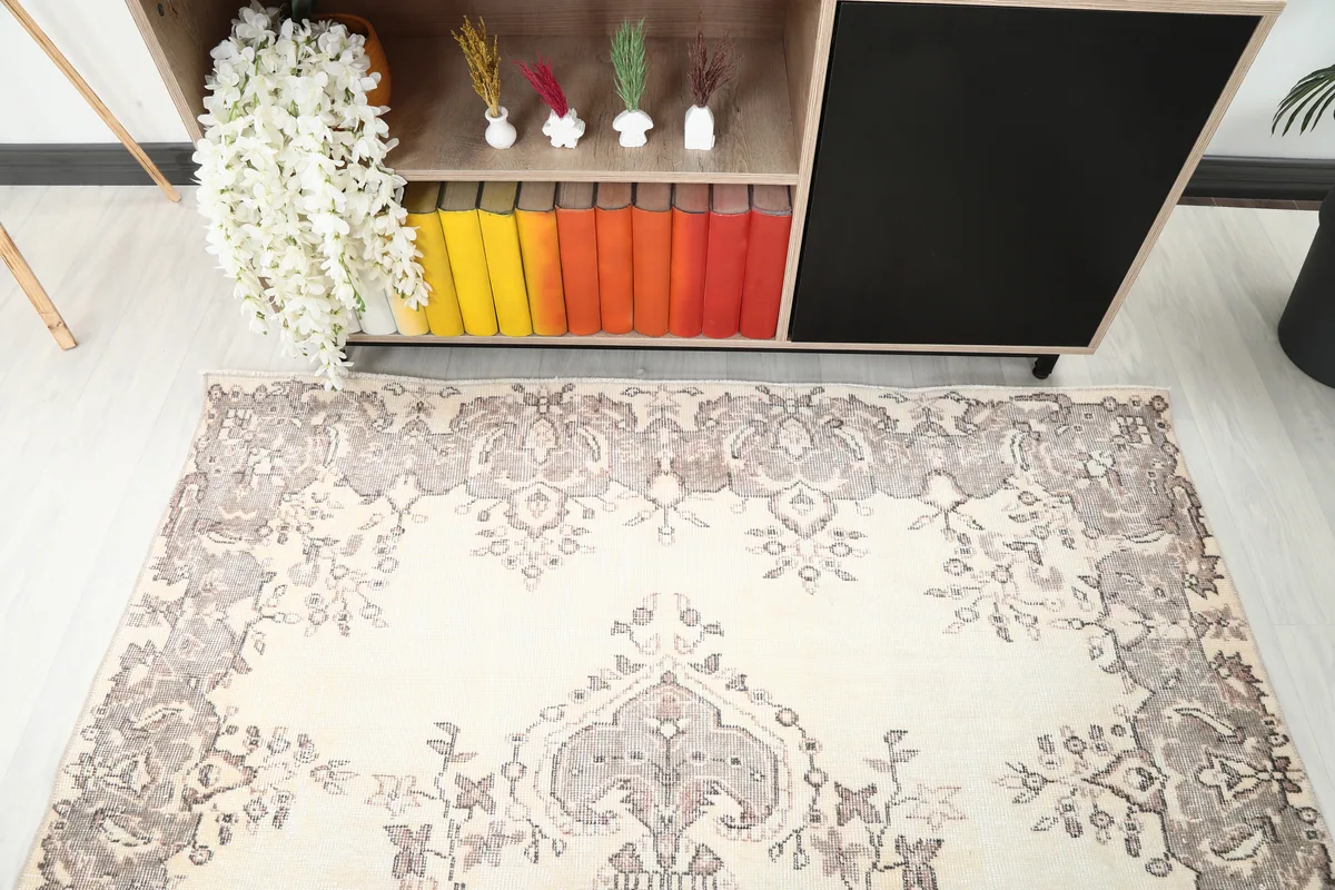 Ivory Gray Medallion Anatolian Rug, angled view of the top section with border and field patterns.