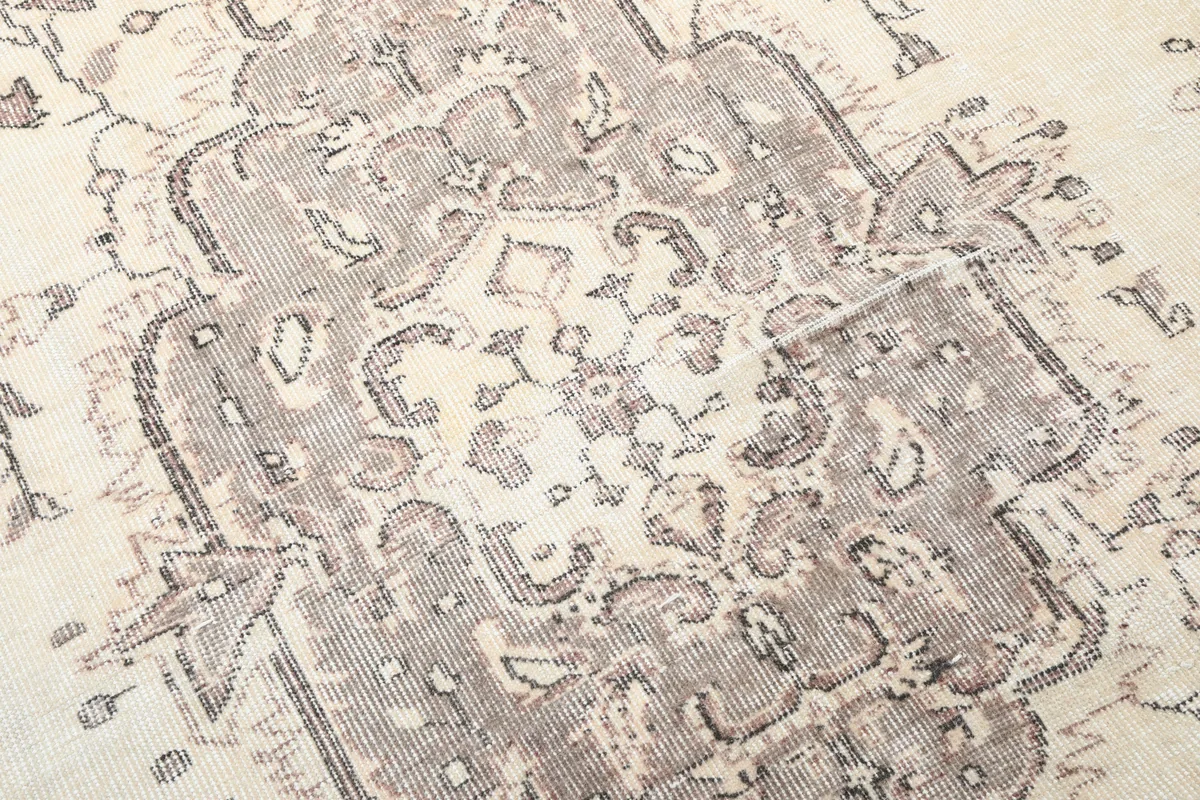 Ivory Gray Medallion Anatolian Rug, close-up of the distressed texture and intricate patterns of the medallion.