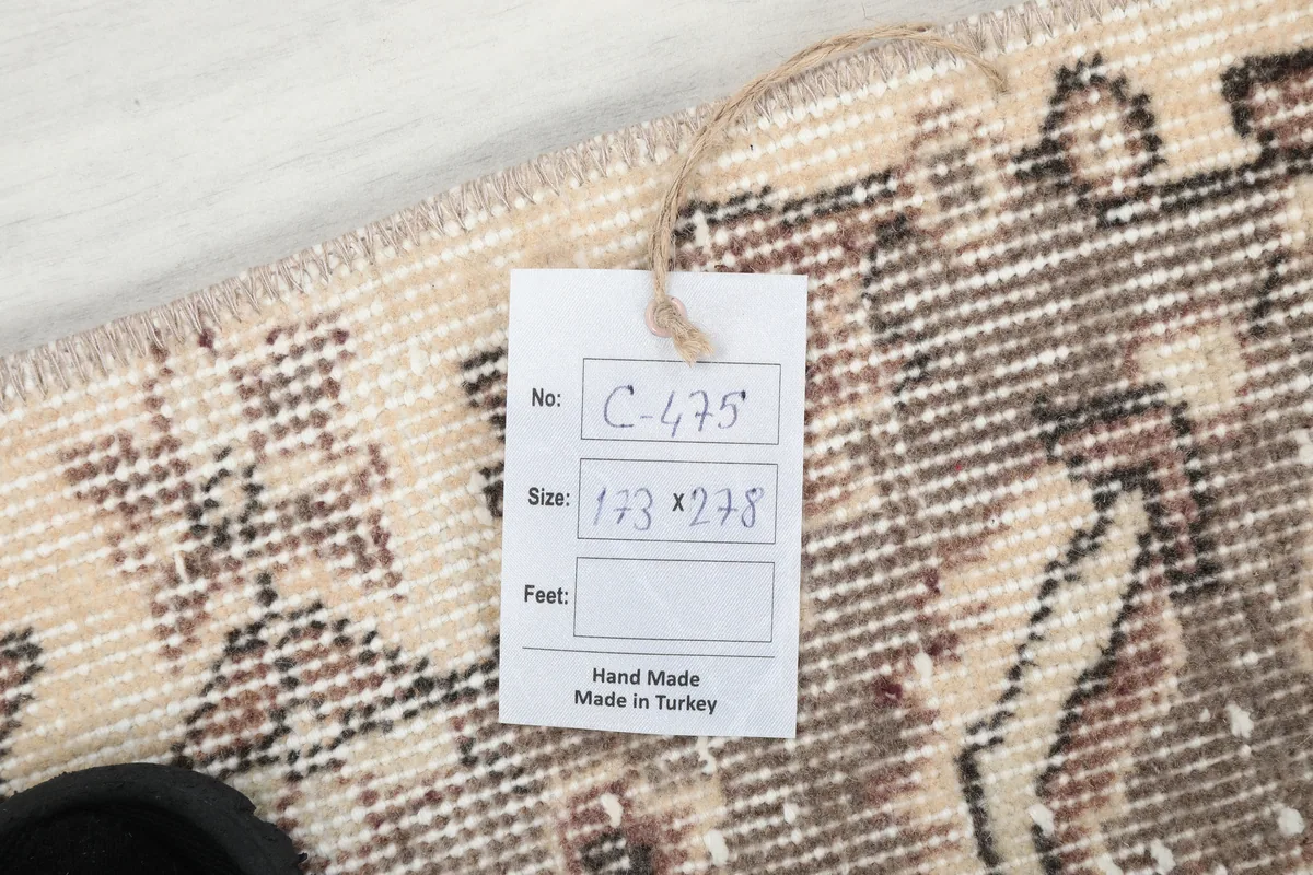 Ivory Gray Medallion Anatolian Rug with a size tag showing dimensions 173 x 278 cm, handmade in Turkey.