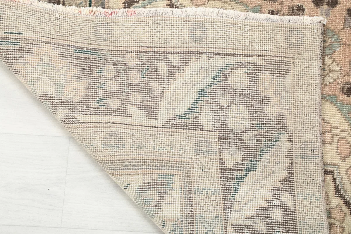 Underside of the hand-knotted rug revealing the cotton foundation and knotting