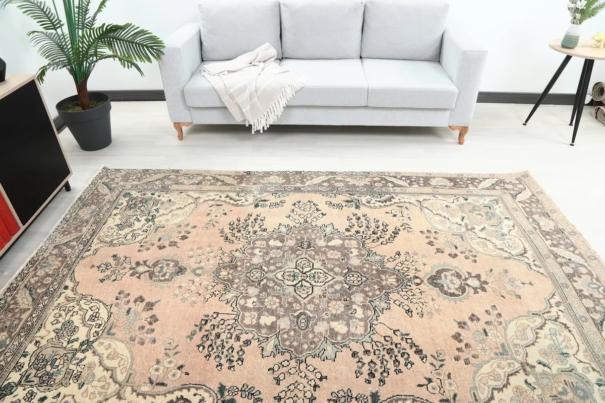 Overhead view showing the central medallion and overall pattern of the rose and brown rug