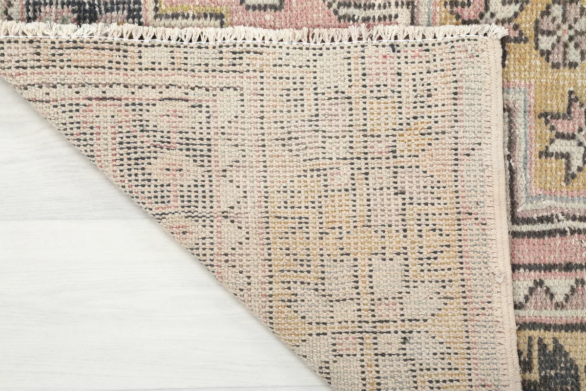 View of the cotton foundation and reverse side of the hand-knotted Pink Gold Geometric Anatolian Rug.