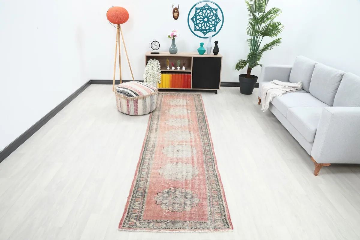 Rose geometric runner in a bright room setting with a light gray sofa and modern decor