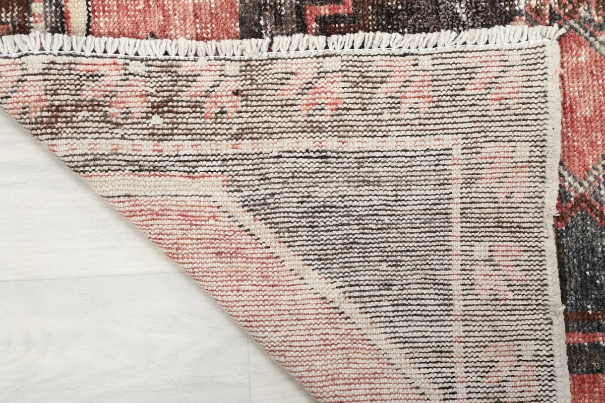 Underside of the hand-knotted runner rug, revealing the woven cotton foundation.
